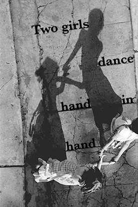 Two girls dance hand in hand
